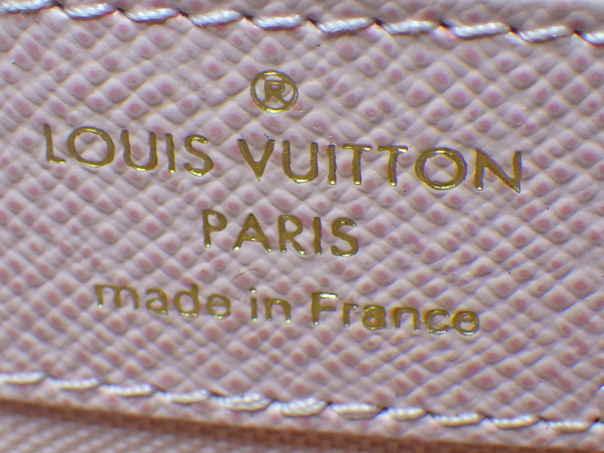 Louis Vuitton logo and text on a textured surface
