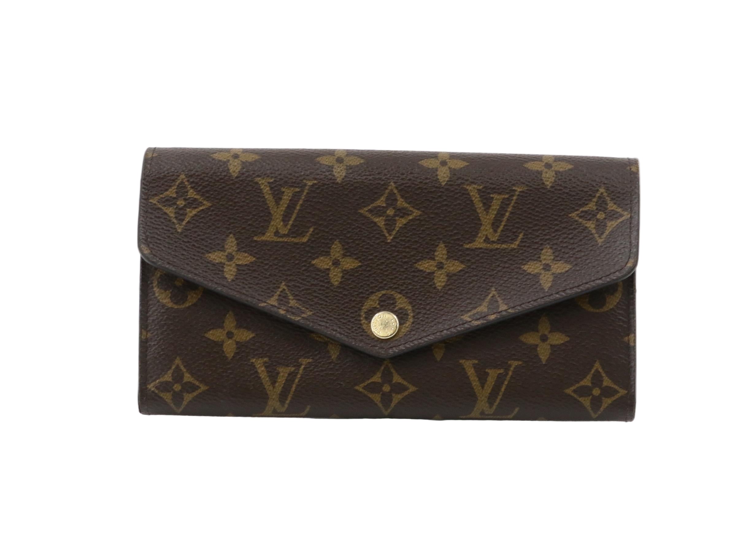Louis Vuitton wallet with monogram pattern on a white background