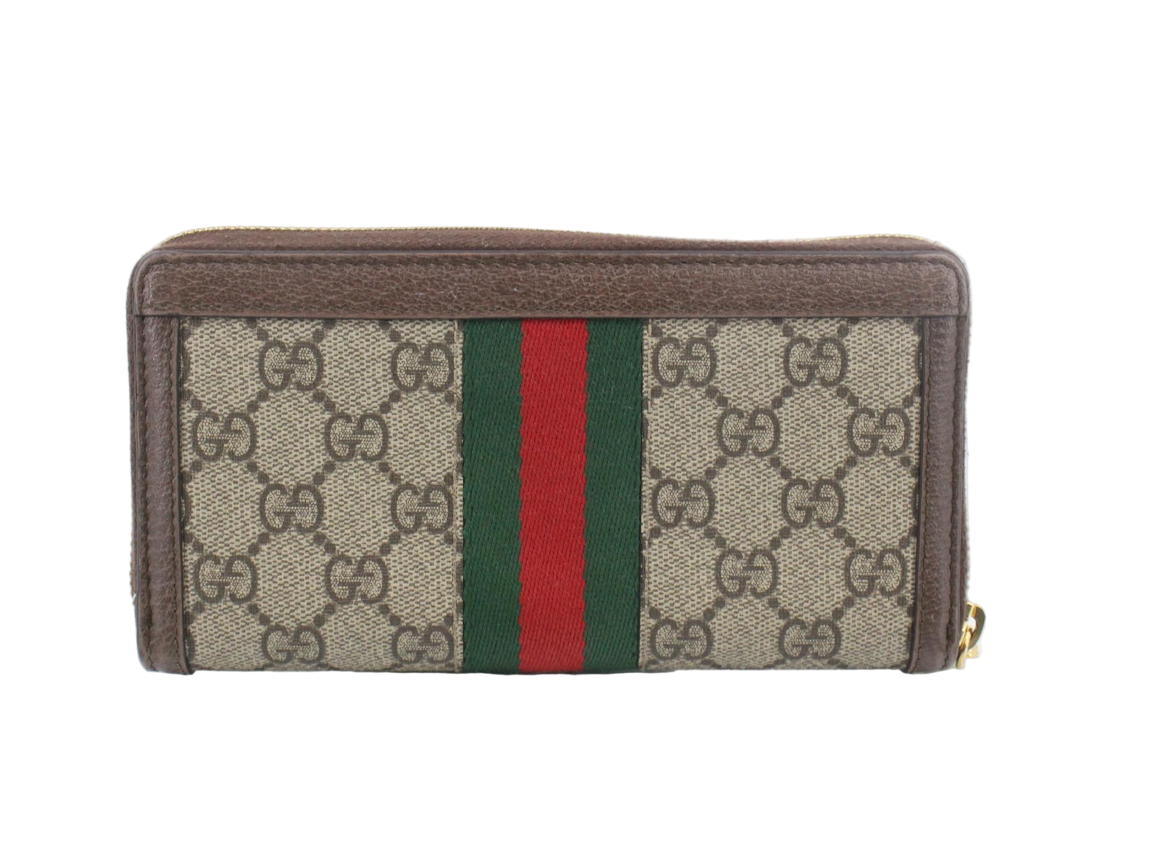 Gucci wallet with monogram pattern and red and green stripes on a white background