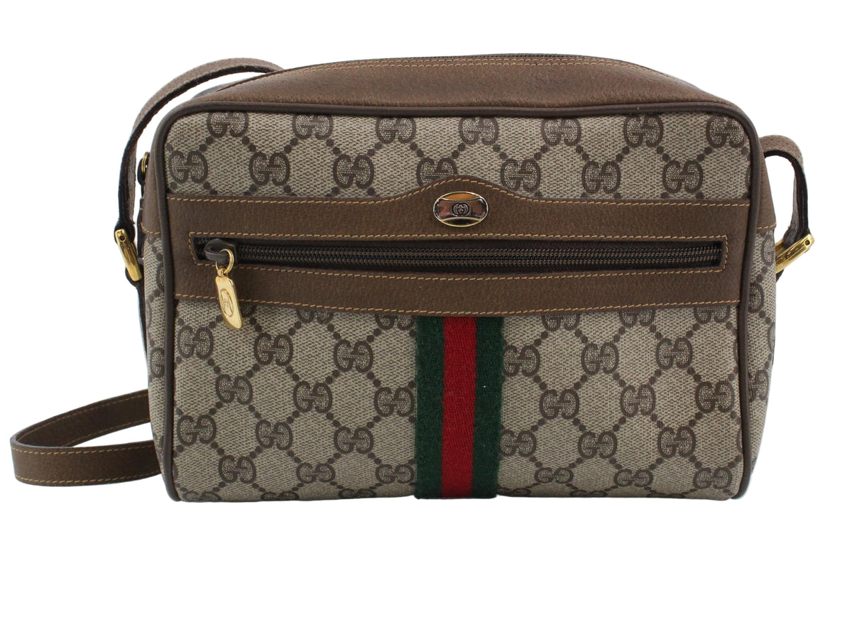 Gucci handbag with patterned design and visible brand logo on a white background