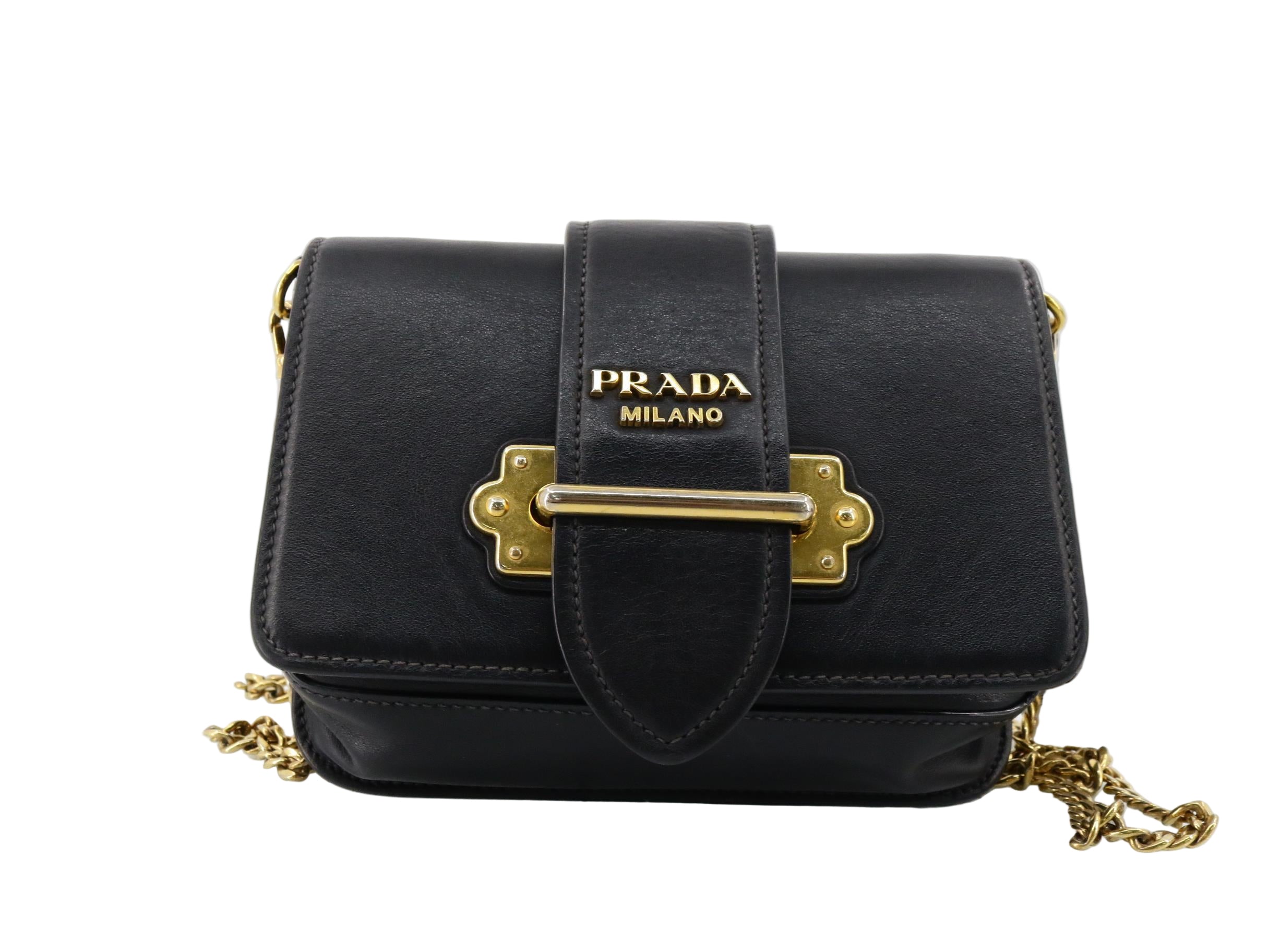Black Prada handbag with gold accents on a white background