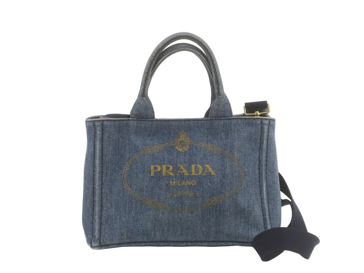 Prada Canapa Denim handbag with Prada logo on a white floor