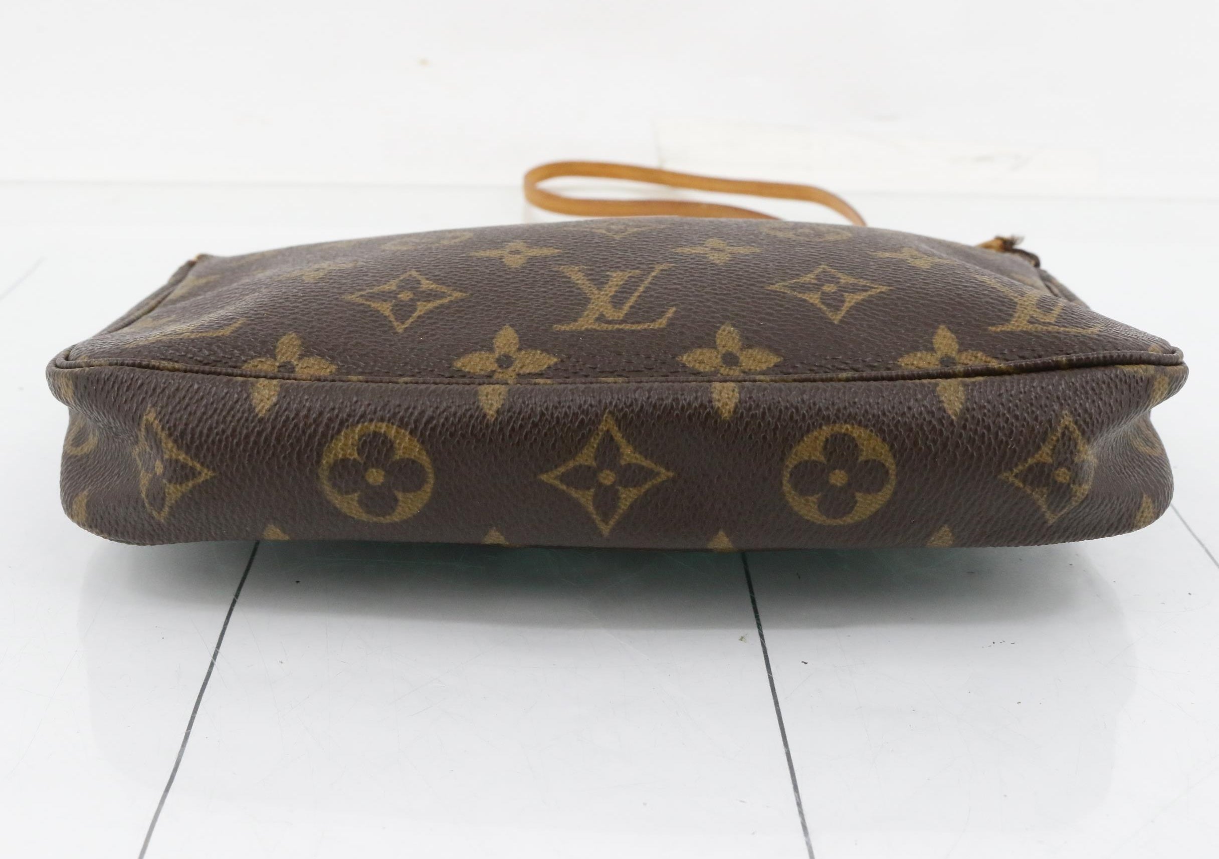 Brown Louis Vuitton handbag with monogram pattern on a white background