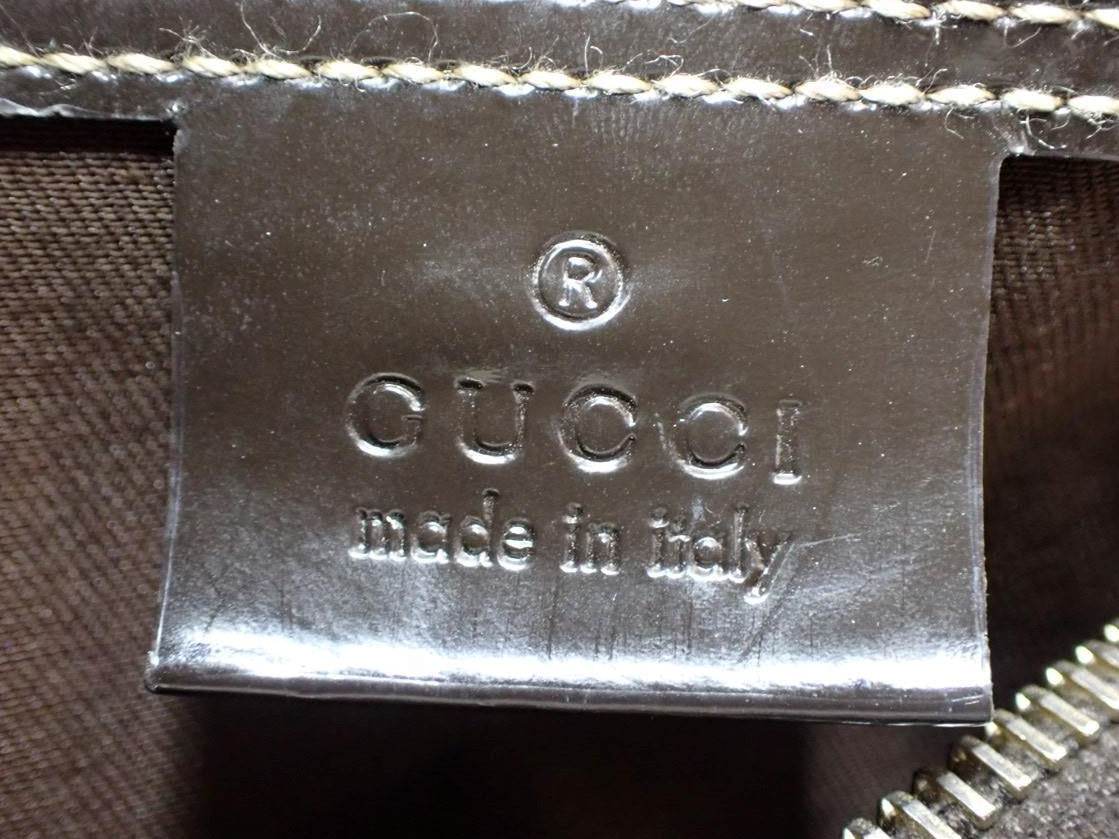 Gucci logo and 'made in Italy' text on a brown textured surface