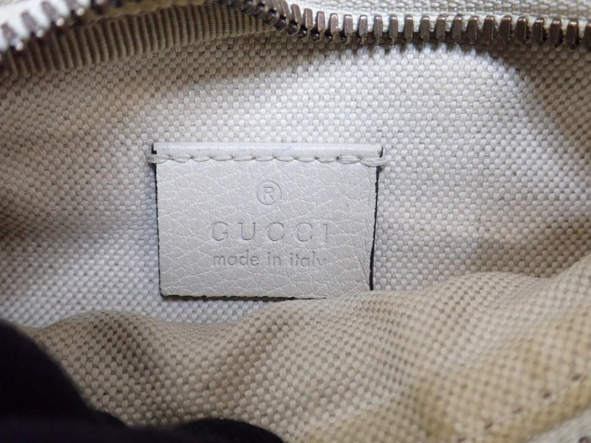 Gucci label on a beige textured surface